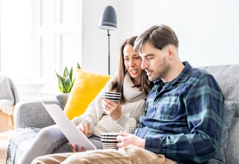 Happy Couple Reviewing Low home bills from Utility Warehouse 
www.best-switch.co.uk